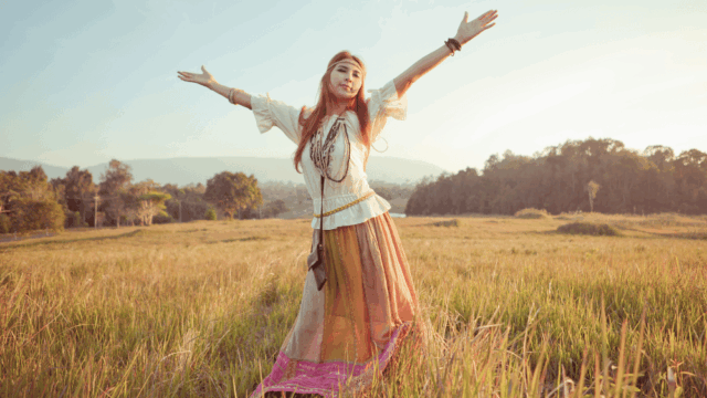 woman in field twirling